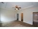 Empty main bedroom with a view of an attached bathroom featuring carpet floors and tray ceilings at 2671 Calvary Dr, Hampton, GA 30228