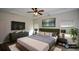 Serene main bedroom with tray ceiling, modern furnishings, and ample natural light from two large windows at 2671 Calvary Dr, Hampton, GA 30228