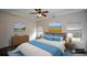 Bright and airy main bedroom featuring a tray ceiling, a wood bed frame, and blue accents for a tranquil feel at 2671 Calvary Dr, Hampton, GA 30228