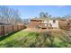 Spacious backyard featuring a wooden fence, a small deck, and a well-maintained lawn at 2968 Cleburne Pkwy, Powder Springs, GA 30127