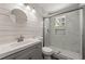 Renovated bathroom featuring shiplap wall, a walk-in shower with marble tile, and a modern vanity at 2968 Cleburne Pkwy, Powder Springs, GA 30127