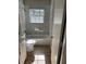 Bathroom features a new sink, toilet and shower with marble tile surround at 2968 Cleburne Pkwy, Powder Springs, GA 30127