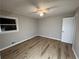 Bedroom features vinyl floors, a fan, and a bright window at 2968 Cleburne Pkwy, Powder Springs, GA 30127