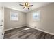 Cozy bedroom featuring gray flooring, neutral walls, and natural light from two windows at 2968 Cleburne Pkwy, Powder Springs, GA 30127