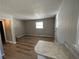 Living room features paneled walls, new vinyl floors, and is freshly painted at 2968 Cleburne Pkwy, Powder Springs, GA 30127