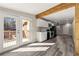 Bright living room with a modern kitchen, gray flooring, and access to the backyard deck at 2968 Cleburne Pkwy, Powder Springs, GA 30127