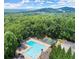 Aerial view of community pool surrounded by lush greenery with mountain views and recreational amenities at 4468 Windsor Oaks Dr, Marietta, GA 30066