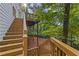 Wooden stairs lead to a backyard deck offering a seamless transition between indoor and outdoor living spaces at 4468 Windsor Oaks Dr, Marietta, GA 30066