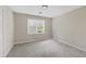Sun-drenched bedroom boasts plush carpeting and natural light from a large window, creating an inviting space at 4468 Windsor Oaks Dr, Marietta, GA 30066
