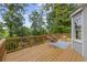 Wooden deck with seating, overlooking a lush treed backyard offers a serene spot for relaxation and entertaining at 4468 Windsor Oaks Dr, Marietta, GA 30066