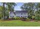 Charming two-story home featuring lush landscaping, a well-manicured lawn, and a classic front facade at 4468 Windsor Oaks Dr, Marietta, GA 30066