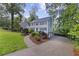 Charming two-story home with a landscaped yard and a curved driveway nestled among mature trees at 4468 Windsor Oaks Dr, Marietta, GA 30066