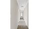 Hallway featuring modern lighting and neutral paint, creating a seamless transition between rooms at 4468 Windsor Oaks Dr, Marietta, GA 30066