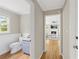 Hallway view of half bathroom and living room with hardwood flooring at 4468 Windsor Oaks Dr, Marietta, GA 30066