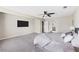Spacious main bedroom featuring carpeted floors, a ceiling fan, and a large wall-mounted television at 4468 Windsor Oaks Dr, Marietta, GA 30066