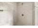 Detailed view of the shower featuring gray tiling with decorative trim and brushed metal fixture at 4468 Windsor Oaks Dr, Marietta, GA 30066