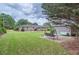 Lush backyard with mature trees, a storage shed, and a swing, ideal for relaxation and outdoor enjoyment at 5478 Janice Ln, Stone Mountain, GA 30087
