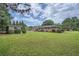 Expansive backyard featuring a well-maintained lawn and mature trees, perfect for outdoor activities at 5478 Janice Ln, Stone Mountain, GA 30087