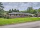Charming brick home with well-manicured lawn, mature trees, and covered porch, offering curb appeal at 5478 Janice Ln, Stone Mountain, GA 30087