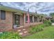 Inviting front porch with charming brick facade, decorative ironwork, and lush landscaping at 5478 Janice Ln, Stone Mountain, GA 30087
