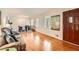 Spacious living room with hardwood floors, large windows, and a view into the dining area at 5478 Janice Ln, Stone Mountain, GA 30087