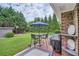 Outdoor patio features an umbrella-covered table and chairs, overlooking a lush backyard at 5478 Janice Ln, Stone Mountain, GA 30087
