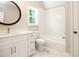Bathroom with white vanity, round mirror, and shower and tub combo at 1150 Sweet Mia Ln, Powder Springs, GA 30127