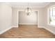 Well-lit dining room with hardwood floors, decorative lighting fixture and a neutral color scheme at 1150 Sweet Mia Ln, Powder Springs, GA 30127
