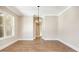 Well-lit dining room with hardwood floors, decorative lighting fixture and a neutral color scheme at 1150 Sweet Mia Ln, Powder Springs, GA 30127