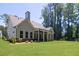 An inviting outdoor covered patio that overlooks a neatly manicured green lawn with professionally landscaped surroundings at 1150 Sweet Mia Ln, Powder Springs, GA 30127