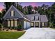 Beautifully landscaped single-Gathering home with a brick facade, two-car garage, and inviting double door entry at 1150 Sweet Mia Ln, Powder Springs, GA 30127