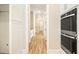 Hallway with wood flooring and access to stainless steel ovens and appliances at 1150 Sweet Mia Ln, Powder Springs, GA 30127