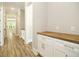Hallway features beautiful floors and white cabinets with light countertops in a newly constructed home at 1150 Sweet Mia Ln, Powder Springs, GA 30127