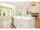 Kitchen with island, sink, stainless appliances, and open to the living room with fireplace at 1150 Sweet Mia Ln, Powder Springs, GA 30127