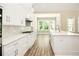 Bright, white kitchen featuring modern cabinetry, quartz countertops, stainless steel appliances, and stylish backsplash at 1150 Sweet Mia Ln, Powder Springs, GA 30127