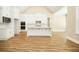 Spacious kitchen with white cabinets, island, and stainless steel appliances, showcasing an open-concept design at 1150 Sweet Mia Ln, Powder Springs, GA 30127