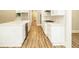 Bright kitchen showcasing white cabinets, countertops, stainless steel appliances, and wood floors at 1150 Sweet Mia Ln, Powder Springs, GA 30127