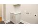 The laundry room features a grey vanity, a white countertop, and hookups for a washer and dryer at 1150 Sweet Mia Ln, Powder Springs, GA 30127