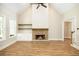Open floor plan showing vaulted ceilings, fireplace with a wood mantle, and built-in cabinets at 1150 Sweet Mia Ln, Powder Springs, GA 30127