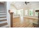 Open floor plan with wood floors, vaulted ceilings, fireplace, and kitchen island at 1150 Sweet Mia Ln, Powder Springs, GA 30127