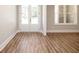 Inviting interior showcasing gorgeous hardwood floors and elegant double doors leading to the front porch at 1150 Sweet Mia Ln, Powder Springs, GA 30127