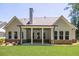 An inviting outdoor covered patio that overlooks a neatly manicured green lawn with professionally landscaped surroundings at 1150 Sweet Mia Ln, Powder Springs, GA 30127