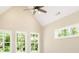 Neutral room featuring windows with outdoor views and an overhead ceiling fan at 1150 Sweet Mia Ln, Powder Springs, GA 30127