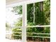Close-up of a window providing a view of lush greenery and the surrounding landscape at 1150 Sweet Mia Ln, Powder Springs, GA 30127