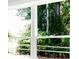 Window view showcases lush green trees and foliage outside at 1150 Sweet Mia Ln, Powder Springs, GA 30127
