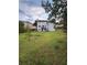 Expansive backyard featuring a white two-story home, and ample green space at 1951 Bergerac Sw Ct, Marietta, GA 30008