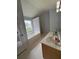 Primary bathroom showing soaking tub under large window at 1951 Bergerac Sw Ct, Marietta, GA 30008