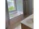 Primary bathroom showcasing soaking tub under large window and walk-in shower at 1951 Bergerac Sw Ct, Marietta, GA 30008