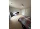 Spacious carpeted bedroom with plaid bedding, desk, and overhead lighting at 1951 Bergerac Sw Ct, Marietta, GA 30008
