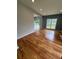 Open-concept living room features beautiful hardwood floors and natural light from large windows at 1951 Bergerac Sw Ct, Marietta, GA 30008